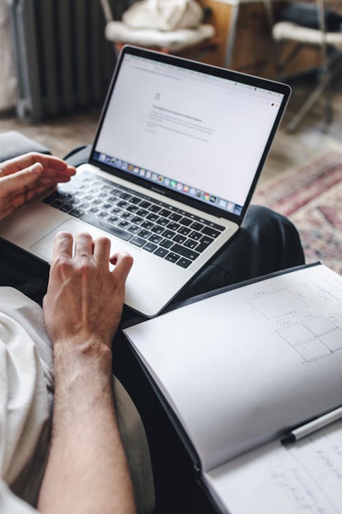 Person researching and comparing adventure sports travel insurance policies on laptop