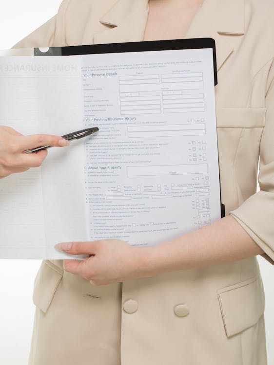 Person holding travel insurance policy document reviewing coverage terms