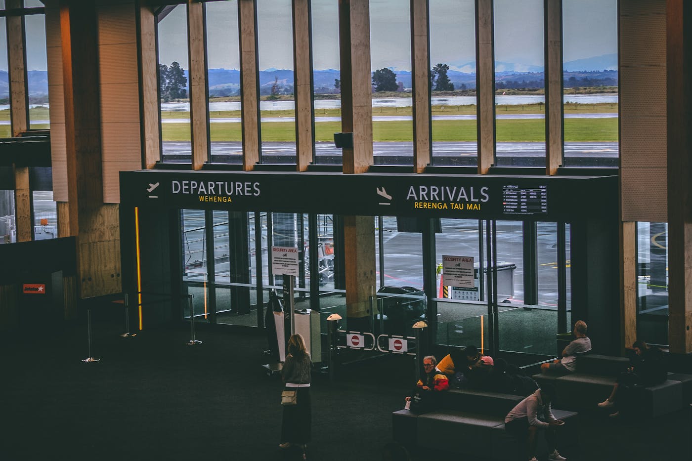 Airport terminal with departures arrivals signs – festival flight booking Europe 2026