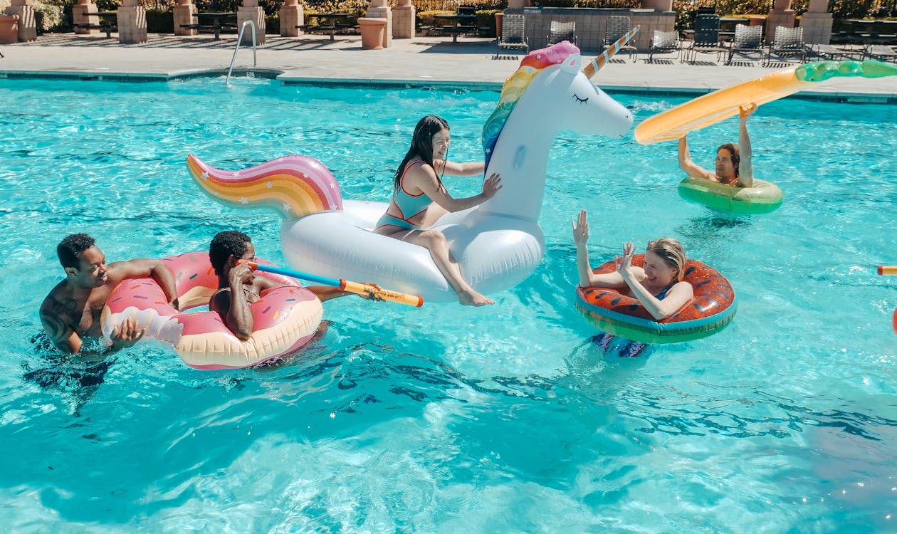 Adults enjoying a tropical pool party in Bali with inflatable floats – why Bali is the ultimate adult destination