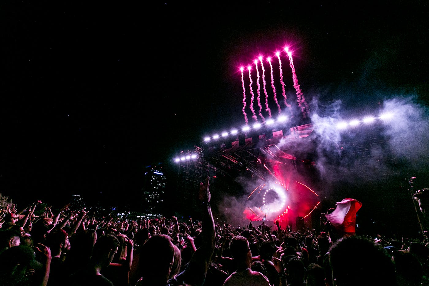 Outdoor hip-hop and urban music festival crowd with fireworks over stage at night 2026