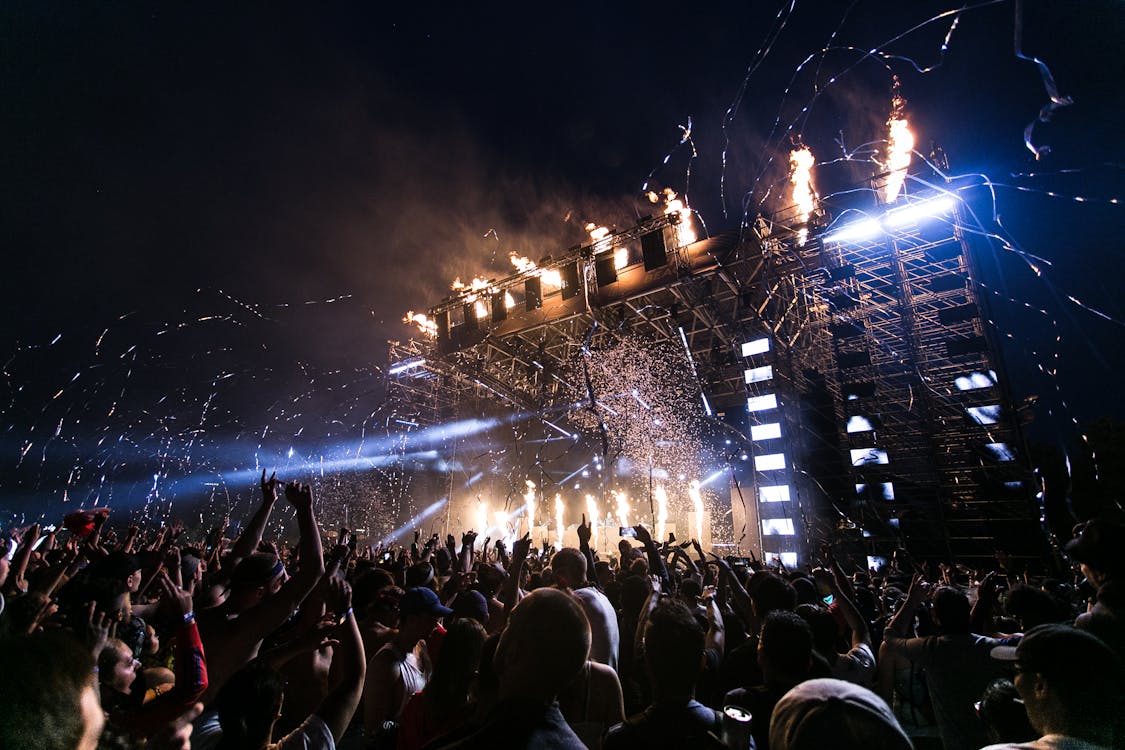 EDM festival crowd with colorful lights β Tomorrowland Belgium first-time experience