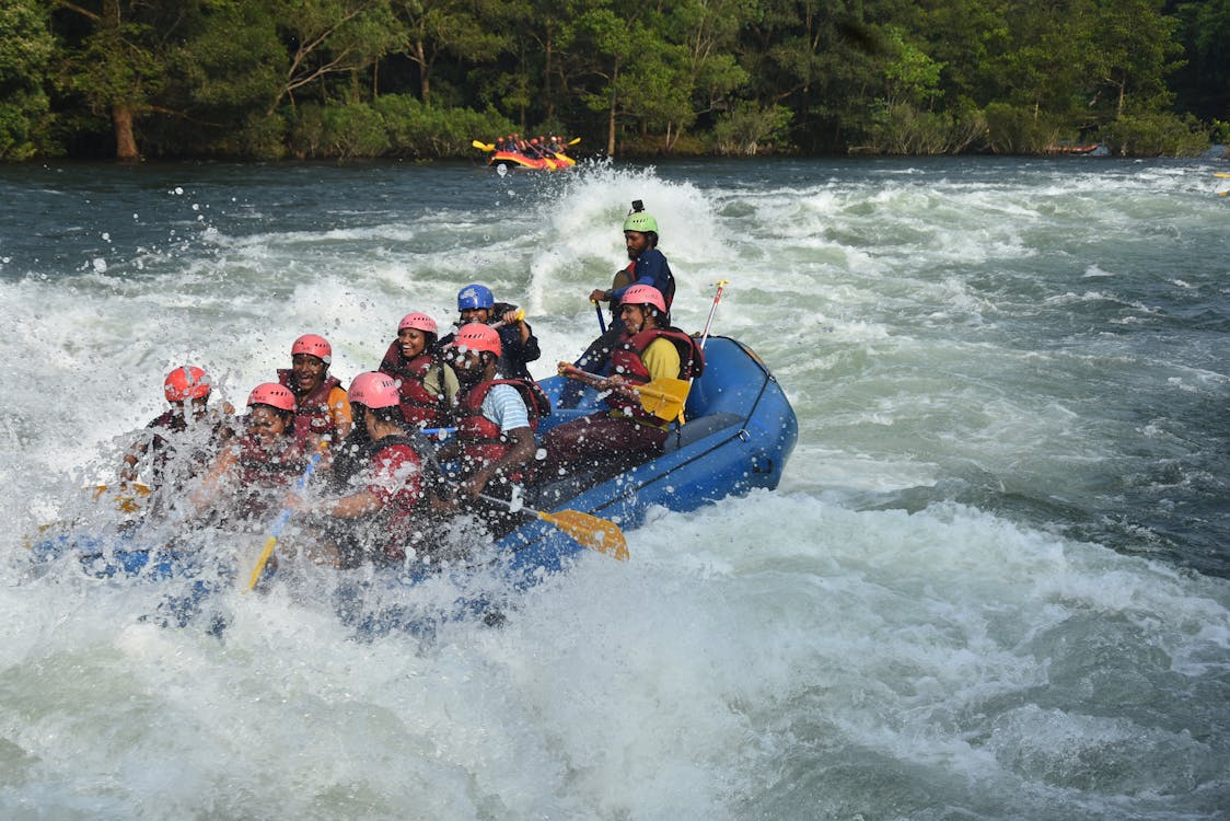 Group of adventurers on white water rafting raft in rapids – Bali Ayung river experience