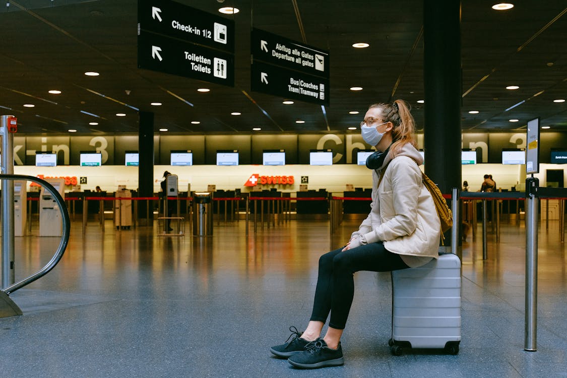 Traveler reviewing documents on laptop – understanding adventure sports insurance policy Europe