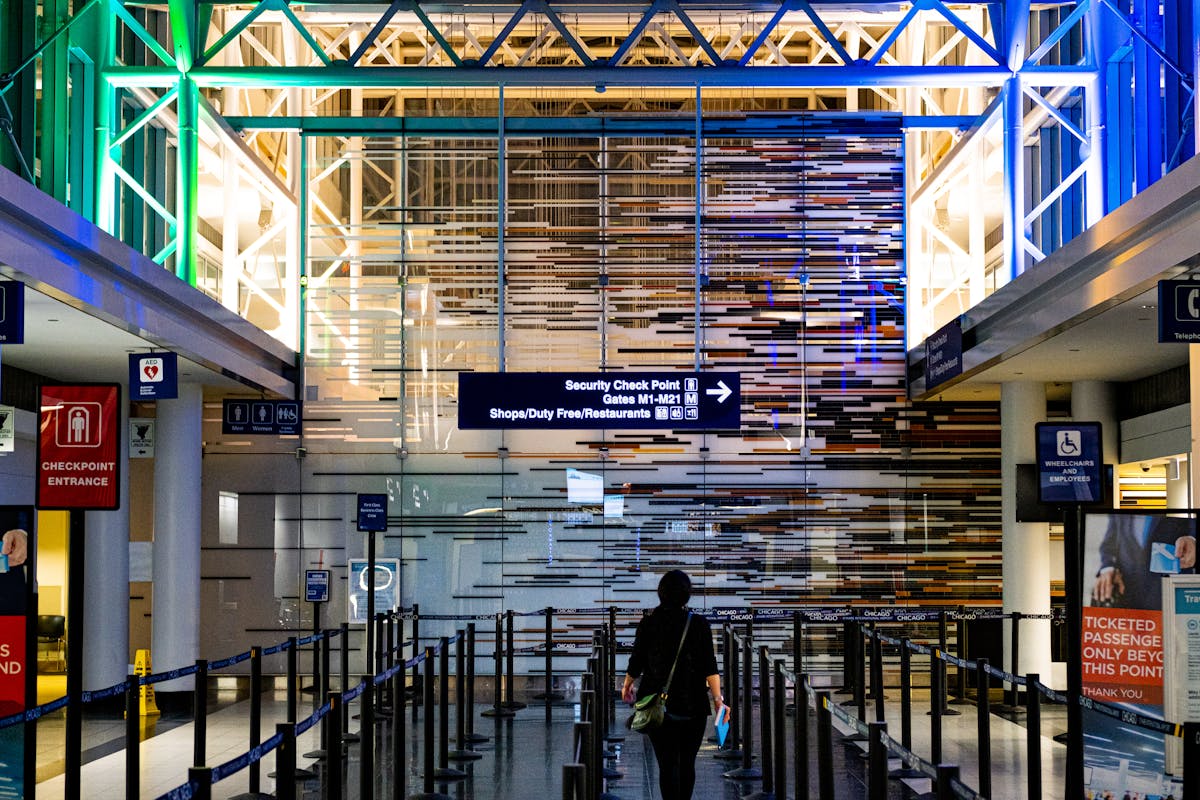 A traveler enters the security checkpoint at an airport terminal