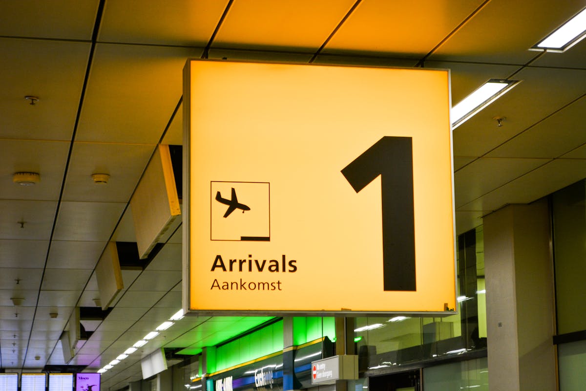Bright arrivals sign with airplane symbol in an airport terminal