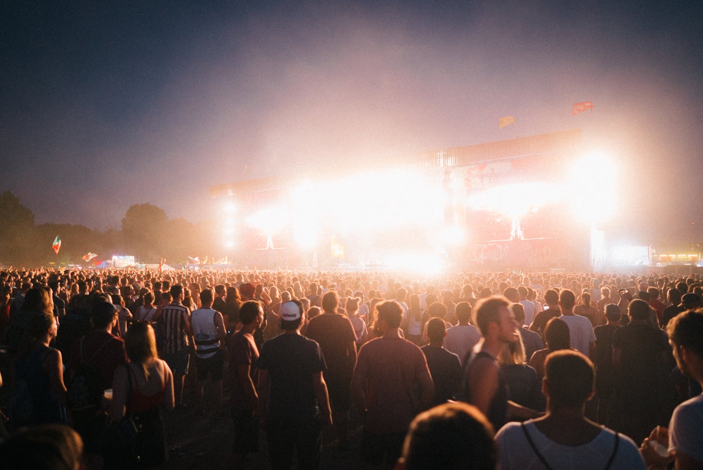 Large crowd at an outdoor music festival in Budapest Hungary at night with stage lights 2026