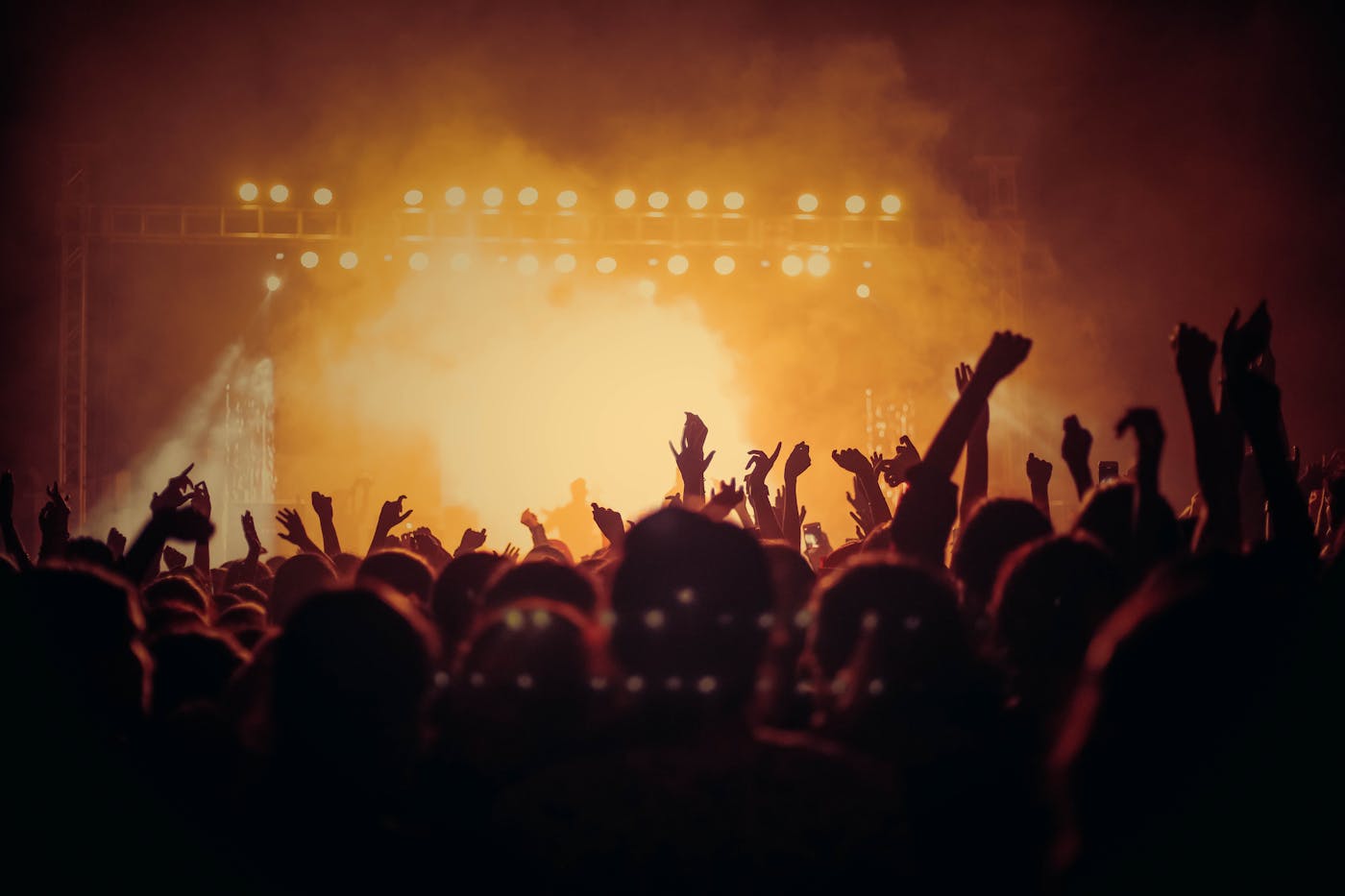 EDM mainstage crowd cheering under bright stage lights at an electronic music festival at night 2026
