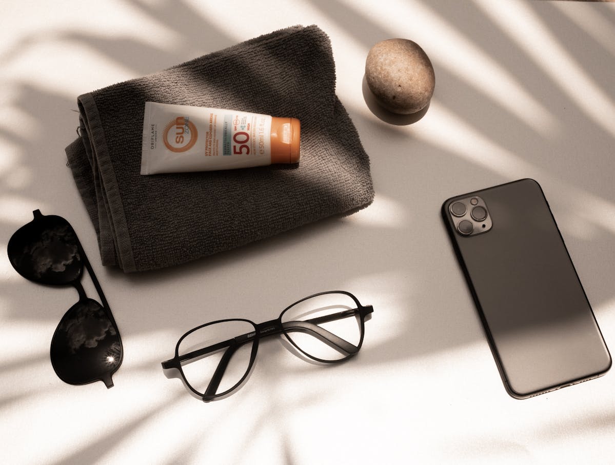 Beach essentials flat lay β sunscreen towel sunglasses summer packing list nude beach