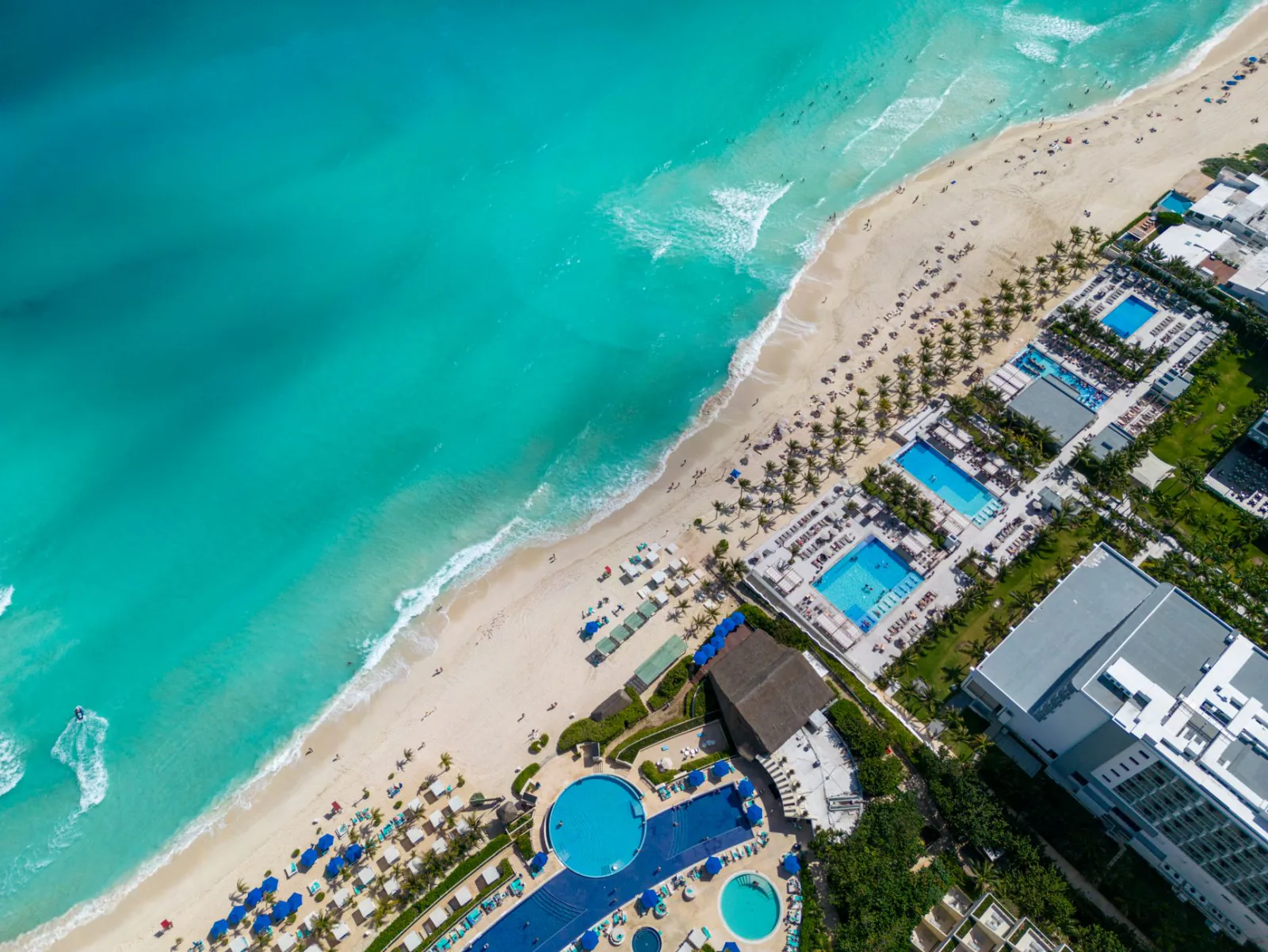 Section 'Temptation Cancun: The Playground in Between' — show: Cancun hotel zone beach resort pool turquoise Mexico. Riv