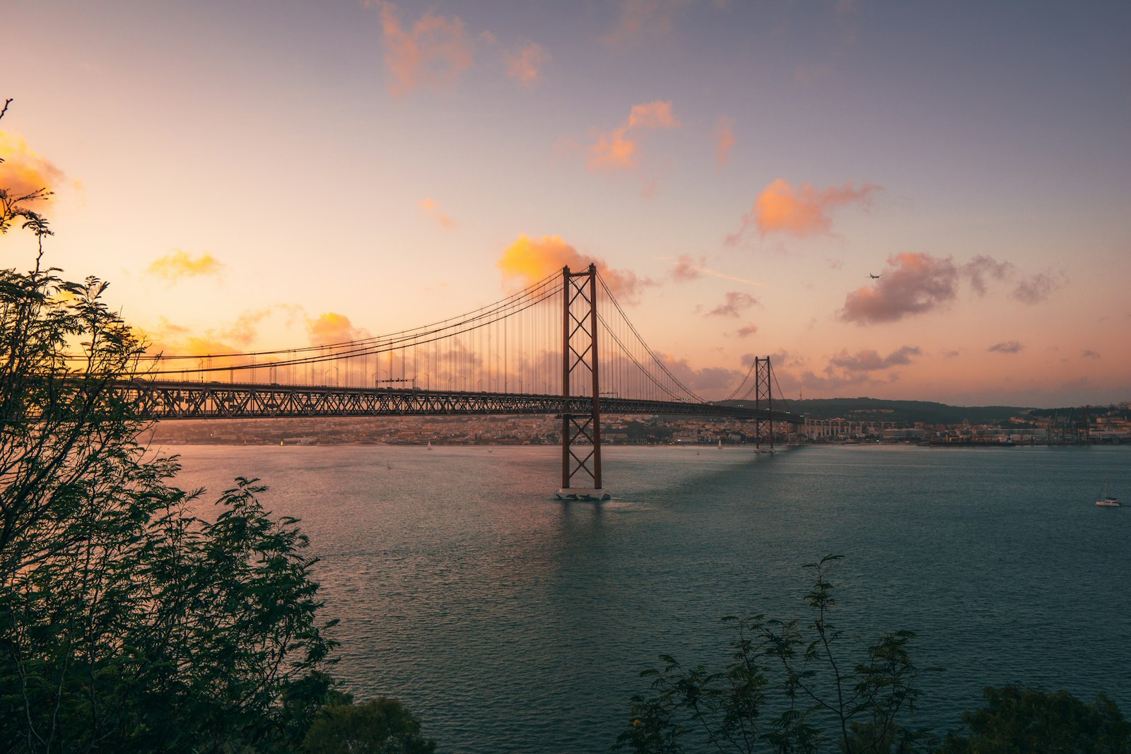 Lisbon 25 de Abril Bridge at golden-hour sunset – Portugal and Spain second summer shoulder season