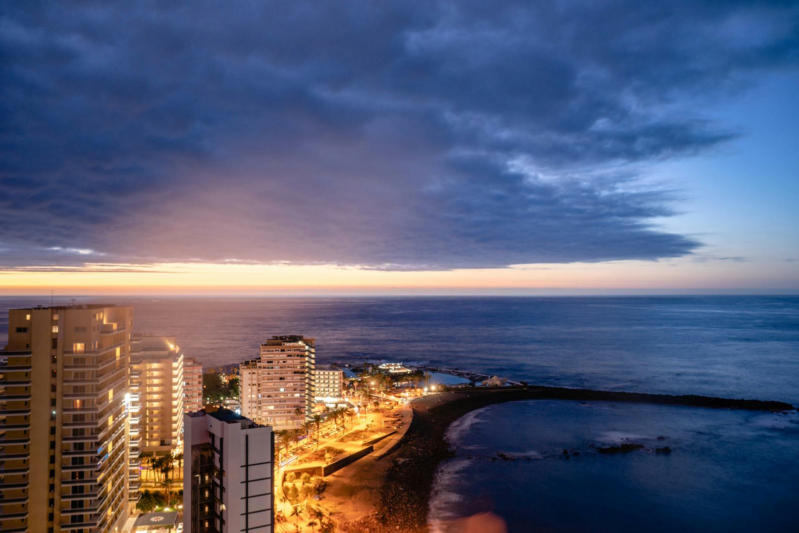 Aerial view of Puerto de la Cruz Tenerife at sunset south vs north party scene