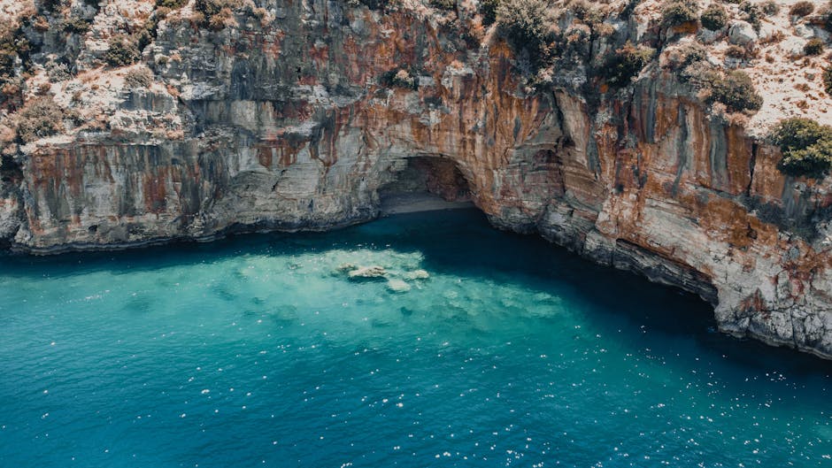 Red rock islet and secluded Mediterranean cove