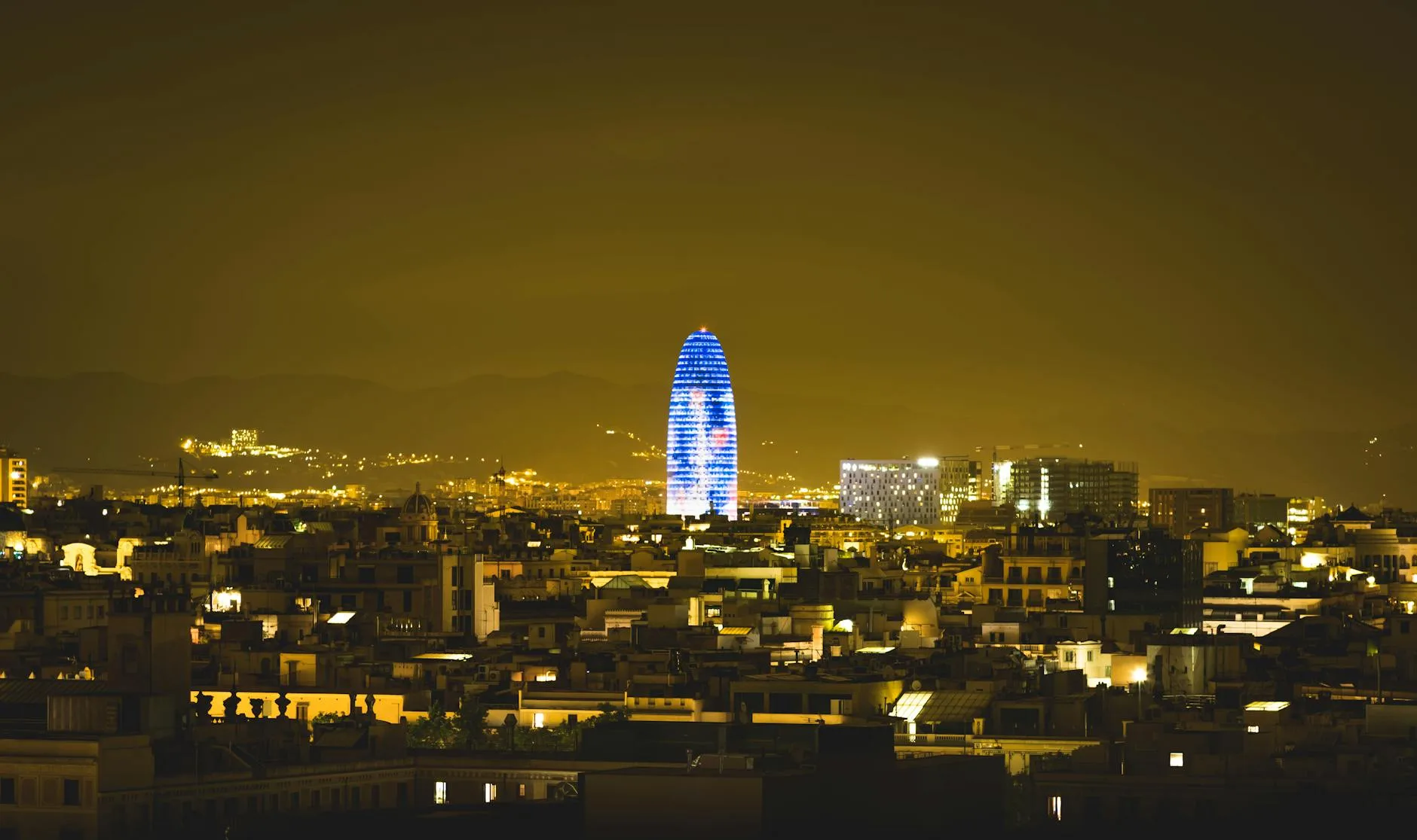 Barcelona city skyline glowing at night β the backdrop to its lifestyle travel scene