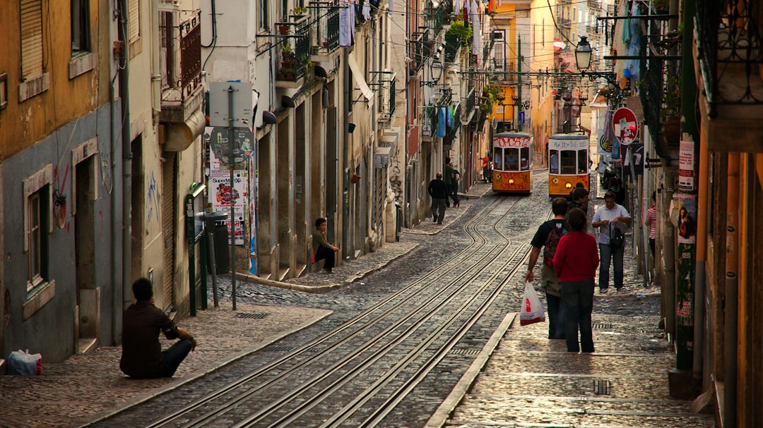 people walking on street near houses at daytime – Best Budget Hostel Neighbourhoods in Lisbon