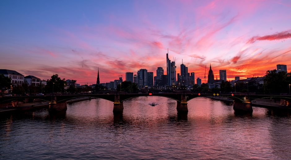 Stunning sunset view over the river in Frankfurt, showcasing its dramatic skyline and reflections. – The Bottom Line on Your First FKK Visit