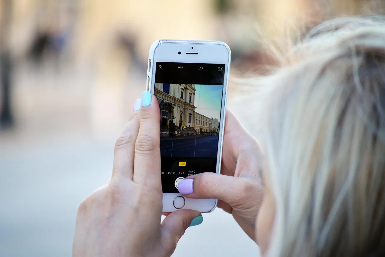 Traveler using a smartphone with a travel eSIM to stay connected in Europe – Airalo vs Saily vs Holafly FAQ