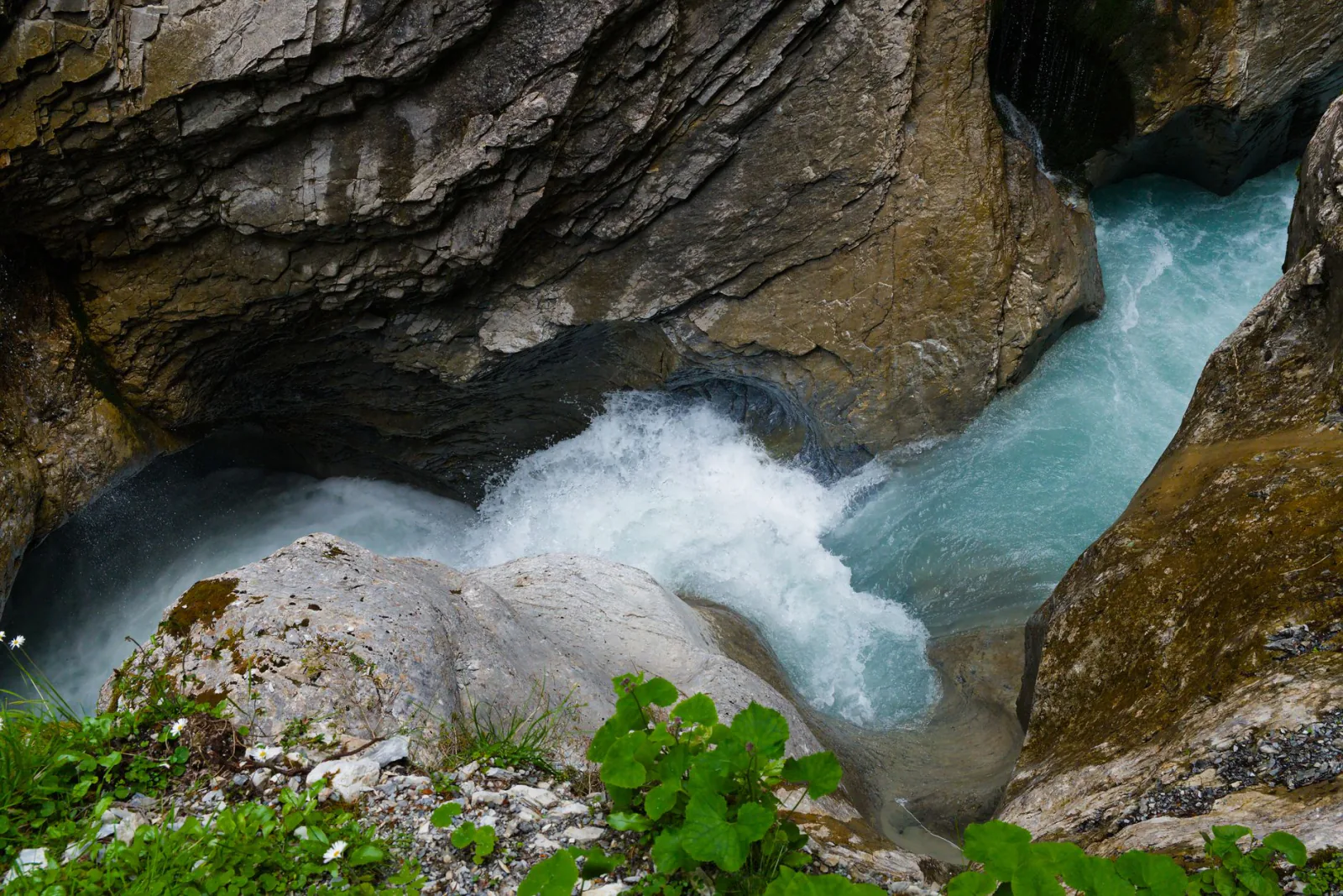 The canyons around Interlaken, Switzerland: deep narrow alpine gorges with turquoise water, waterfalls and steep rock wa