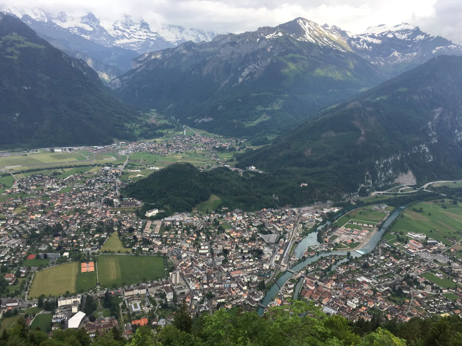Getting to Interlaken: the Swiss town between two lakes, reached by scenic train through the Alps - railway, town street