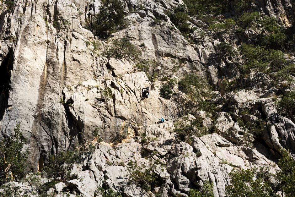Two climbers ascend a rugged mountain face, showcasing adventure and skill. – Rock Climbing in Kalymnos: Why This Greek Island Is a Bucket-List Crag