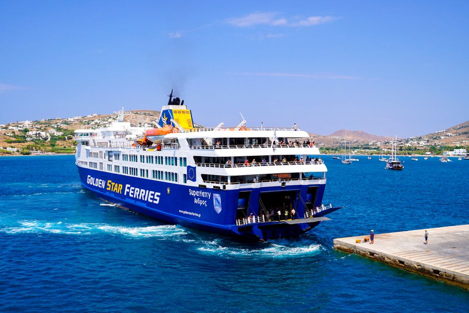 A vibrant image of a Golden Star ferry approaching a Greek island pier under a clear blue sky. – Getting to Kalymnos: Flights, Ferries and Getting Around