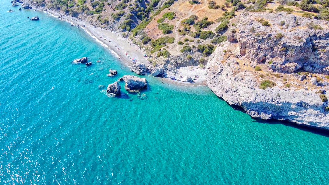 green and brown mountain beside body of water during daytime – Crete's South Coast: Vritomartis Resort, Glyka Nera & Sougia