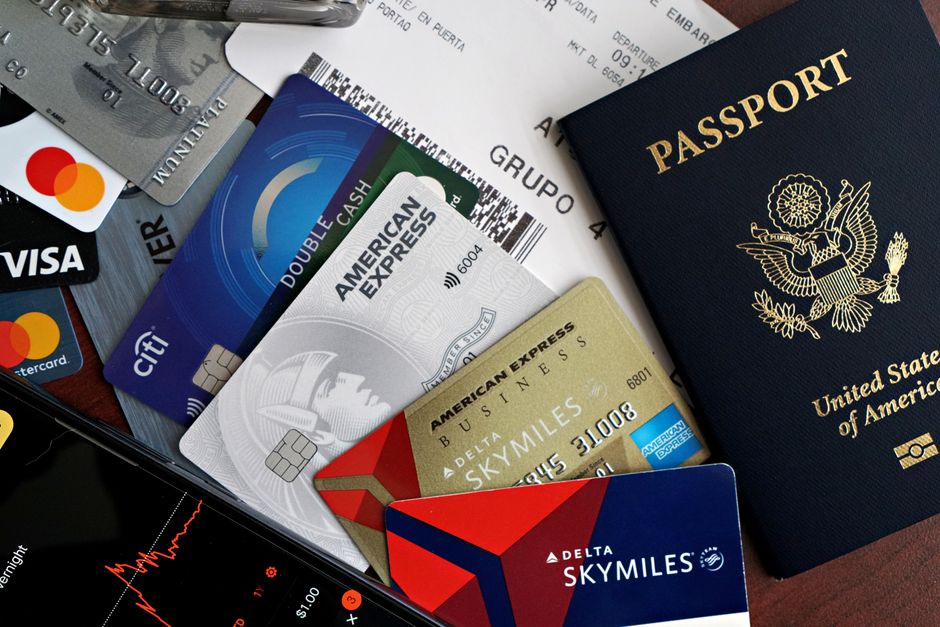 A collection of travel essentials including a passport, credit cards, and a boarding pass. Ideal for travel and finance concepts. – What Are Travel Credit Card 