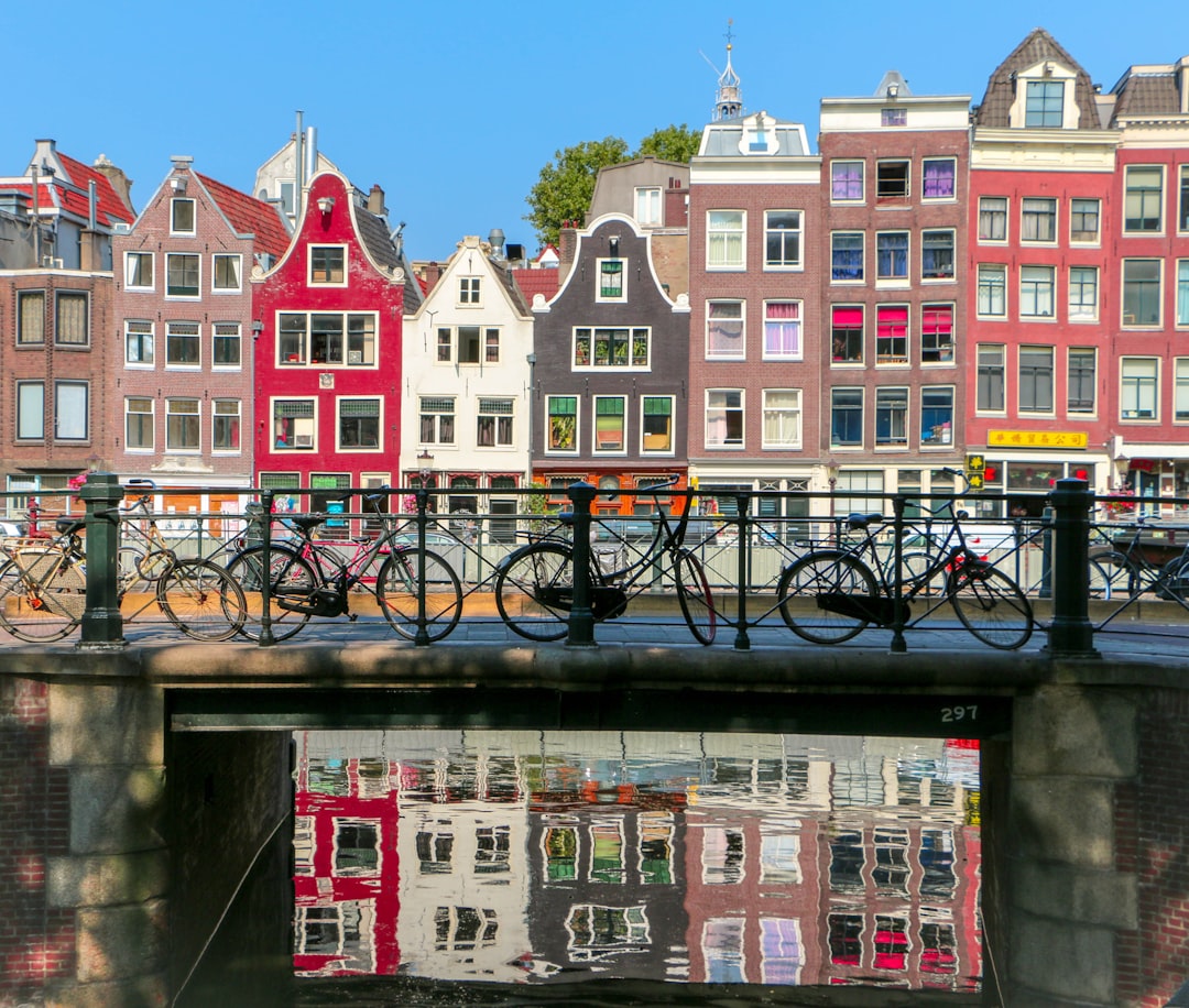 black bicycle leaning on black metal fence – Planning Your Amsterdam Lifestyle Trip
