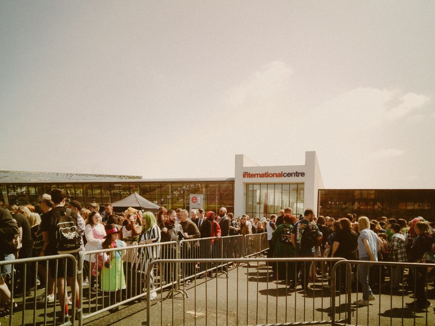 Large crowd gathering outside the International Centre under sunny skies. – Tickets: Prices, Sold-Out Status, and How to Still Get In