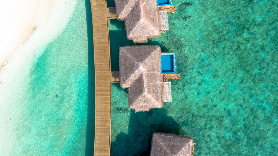 Stunning aerial view of overwater bungalows in the Maldives surrounded by turquoise waters. – 2. You & Me by Cocoon — Raa Atoll's Michelin-Recognized Escape