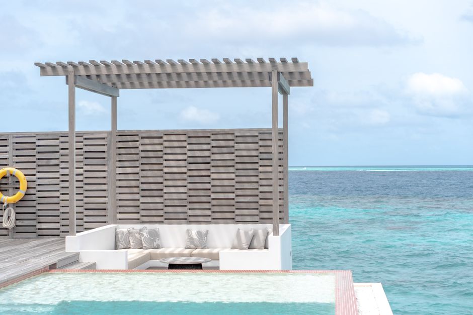 Luxurious beachfront cabana overlooking the turquoise ocean, perfect for relaxation in a tropical paradise. – 3. Anantara Veli Maldives Resort — Closest Luxury