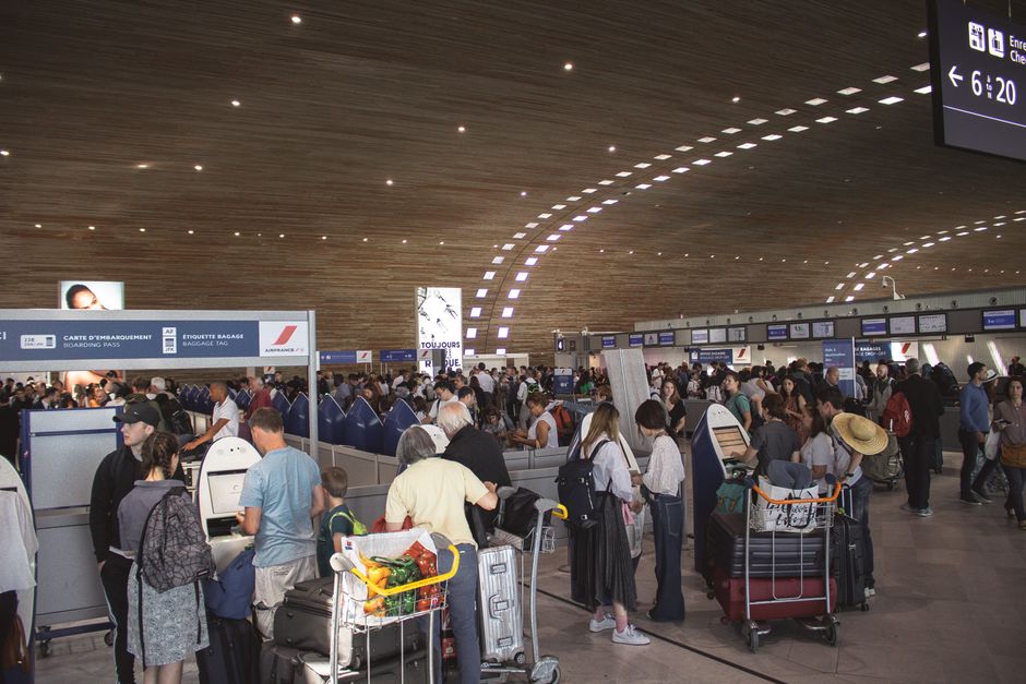 Crowded airport terminal with travellers in line. Indoor setting with modern architecture. β 6. Filter by Baggage Fees Before You Compare Totals
