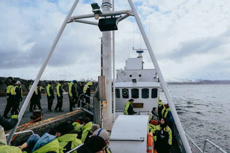 Scenic whale watching tour in Árskógssandur, Iceland with passengers on a boat ready to explore. – Getting to Iceland and Booking Your Tour