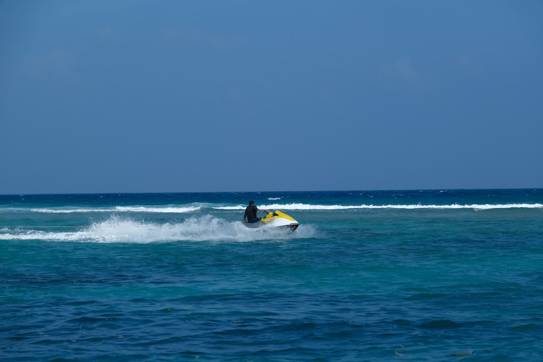 A person riding a jet ski on the ocean. – 6. Centara Ras Fushi Resort & Spa — Best for Water Sports Between Dives