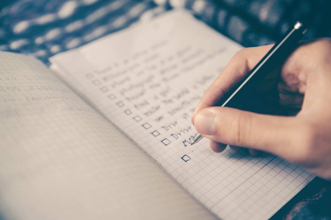 person writing bucket list on book – Quick Planning Notes Before You Book