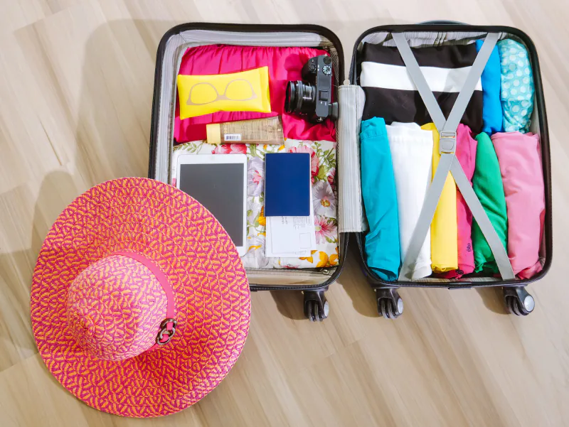 Packed suitcase with travel essentials – what to bring to an FKK club, Germany