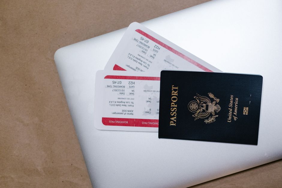 Close-up of a passport and boarding passes on a laptop, symbolizing travel preparation. – What to Check Before You Book