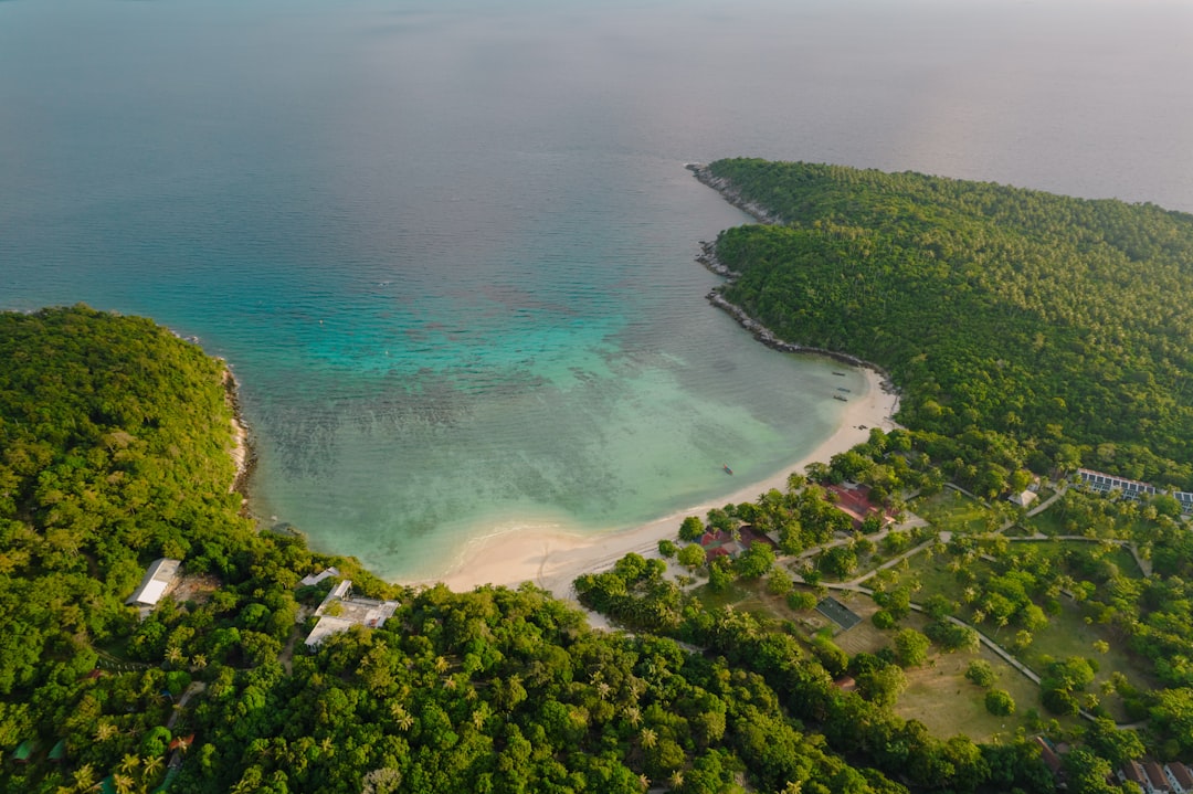 An aerial view of a tropical island surrounded by trees – 3. The Racha — Best for Total Privacy