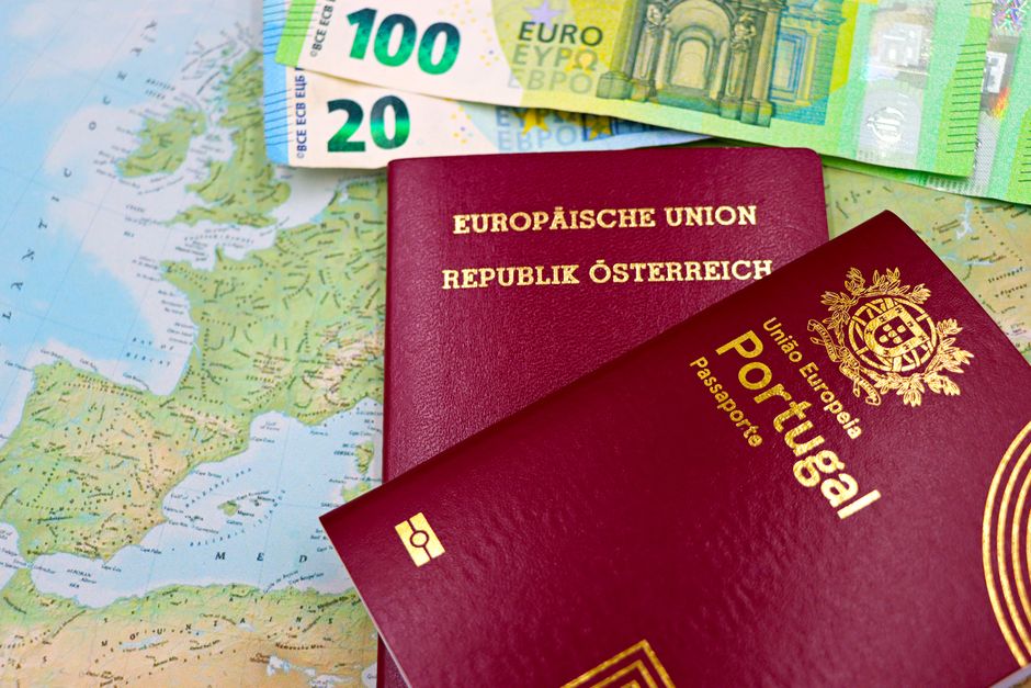 Austrian and Portuguese passports on a European map with euro banknotes. – Which European Countries Offer Digital Nomad Visas in 2026?