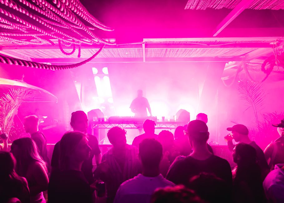 Energetic nightclub scene with DJ and crowd in vibrant pink lighting in North Fremantle, Australia. – When Is Zamna Tulum 2027? Dates and the Multipass Explaine