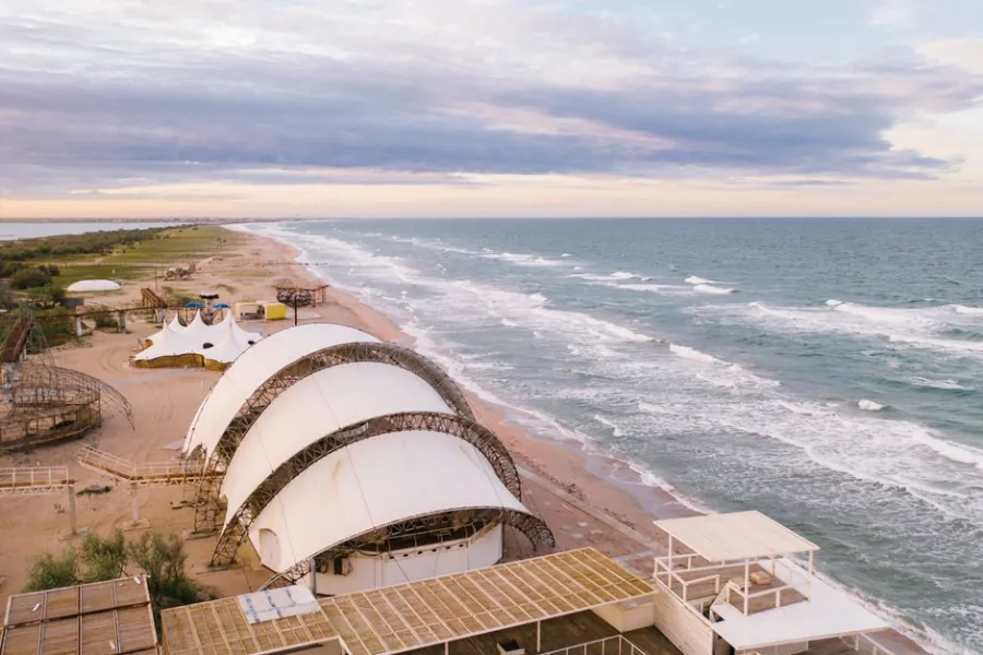 Aerial view of unique structures on Popivka beach with an expansive seascape. – Beach, Please! 2027 — Dates, Location & Ticket Prices