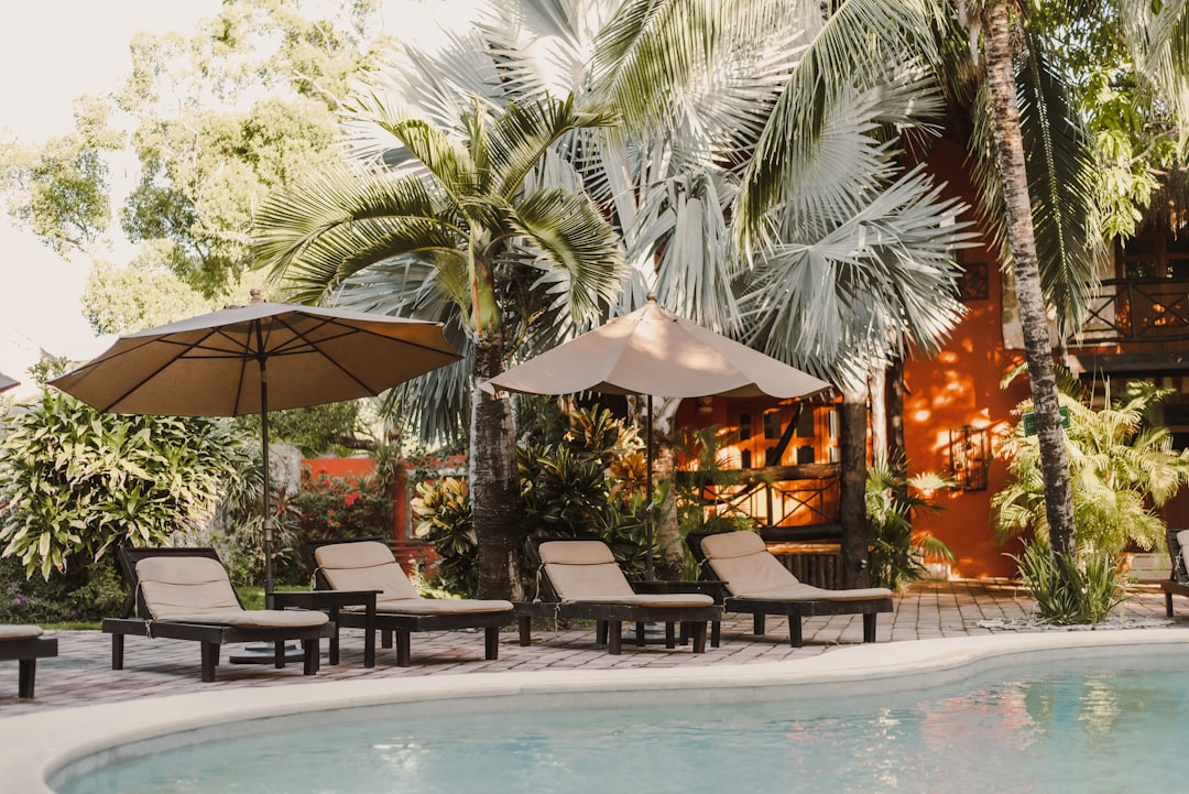 a couple of lawn chairs sitting next to a swimming pool – Tickets and Prices: General Admission vs VIP