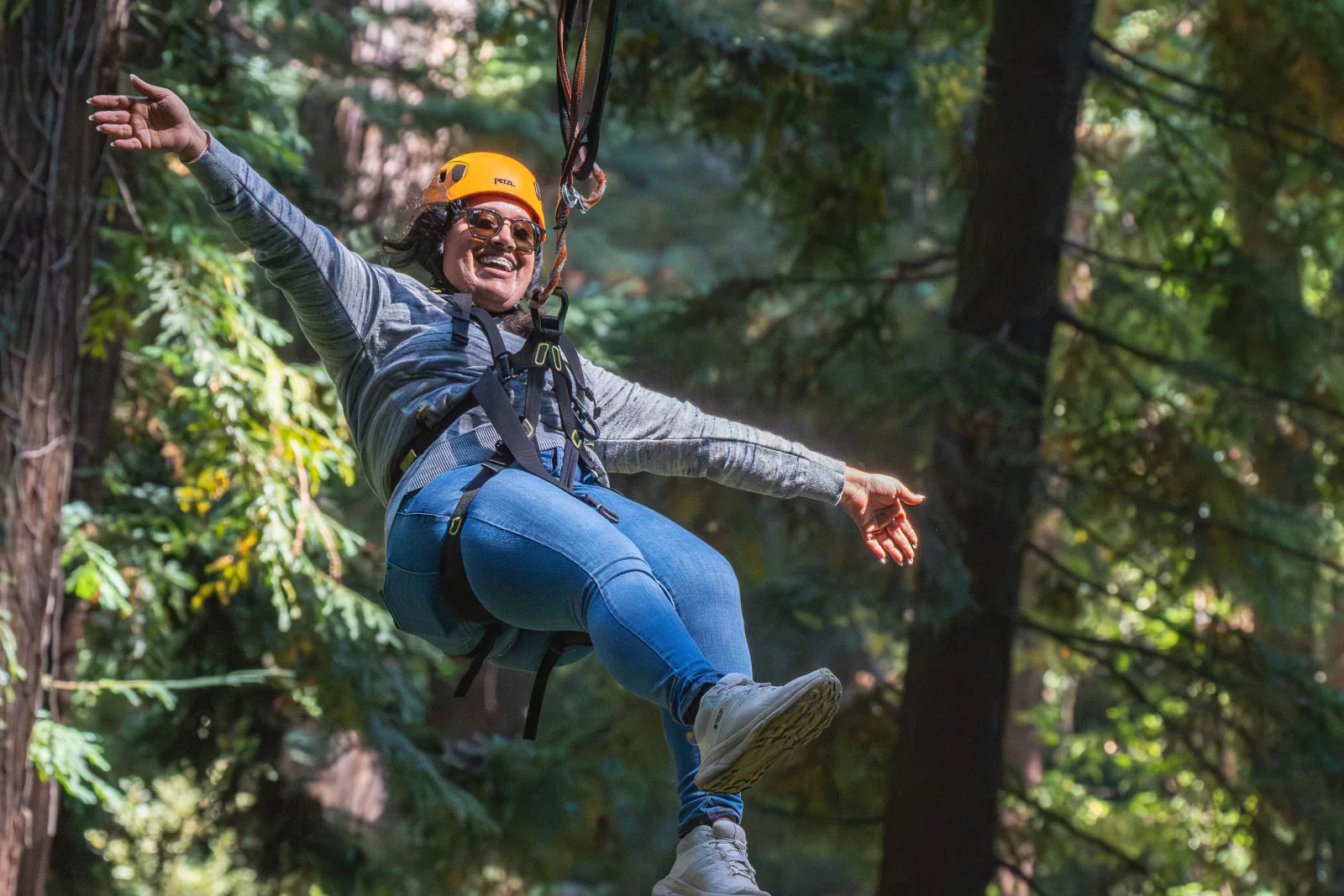Woman ziplining through a lush forest, embracing adventure and enjoying the thrill of nature. – Best Zipline Canopy Tours in Costa Rica by Region