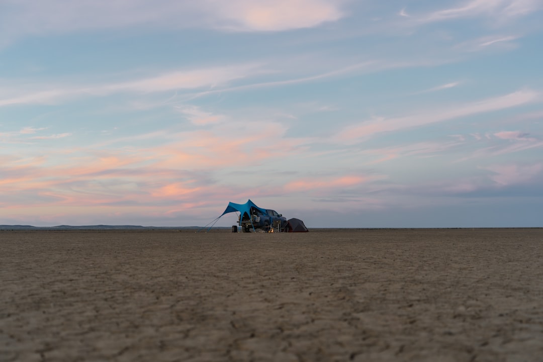 Blue object on dry desert floor under a colorful sky – Tickets, Prices and How the Sale Tiers Actually Work