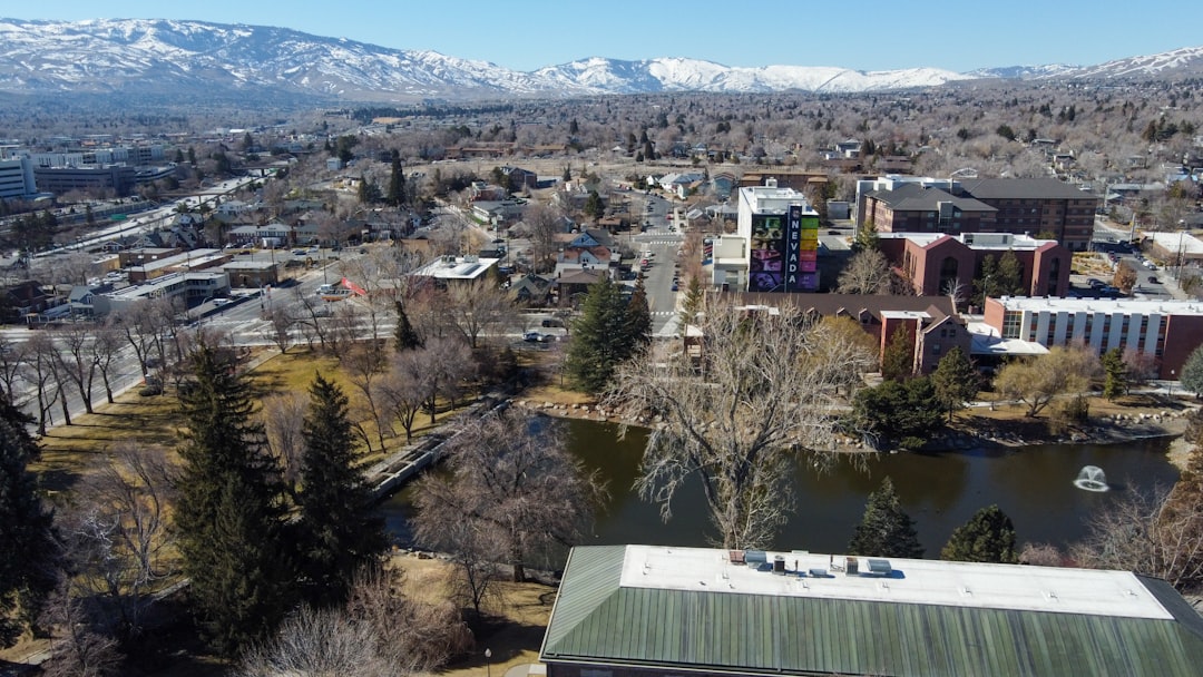 an aerial view of a city with mountains in the background – Getting There: Flights to Reno, Gate Road and Vehicle Passes
