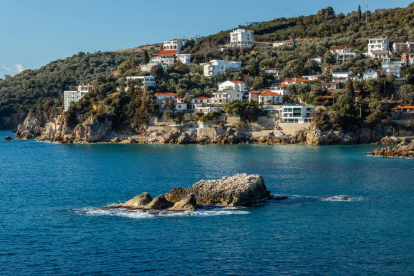 Hillside villas overlooking the rocky Adriatic coastline near Ulcinj, Montenegro – What Will EXIT 2026 Cost You?