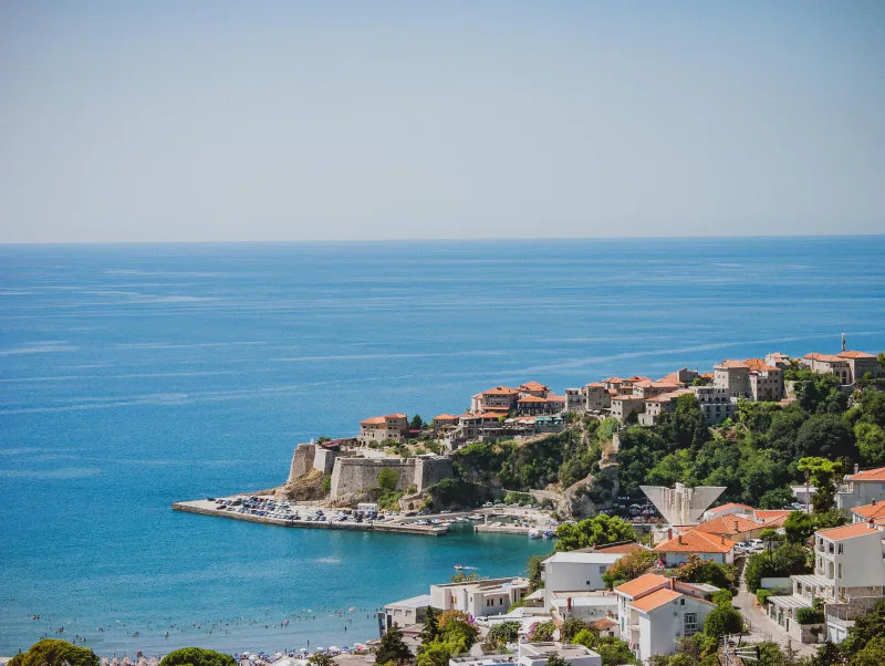 Aerial view of Ulcinj's old town fortress jutting into the Adriatic Sea – First-Timer Survival Tips for a Beach EXIT