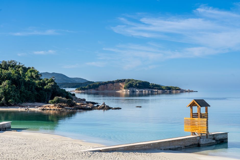 Beautiful beach with clear waters and lush greenery in Ksamil, Albania. – Getting to Ksamil and Where to Stay