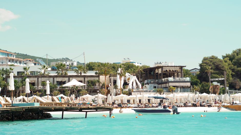 Explore the bustling beachside scene at a sunny resort in Ksamil, Albania. – Ksamil vs Saranda: Which Beach Club Scene Fits You