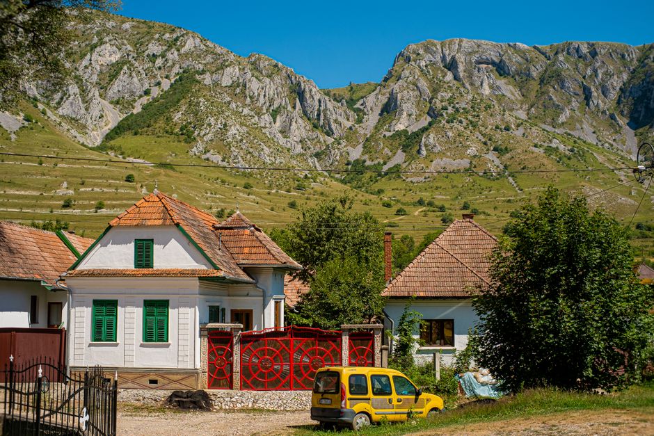 Picturesque village scene with traditional houses nestled against a stunning mountain backdrop. – 3. Romania: The Cheapest Country in the EU